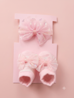 Baby girl's charm with this elegant set featuring a soft, shimmering bow headband and matching cushioned booties