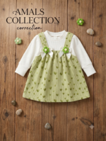 Green corduroy pinafore dress features a sweet heart pattern and charming white bow accents with floral details